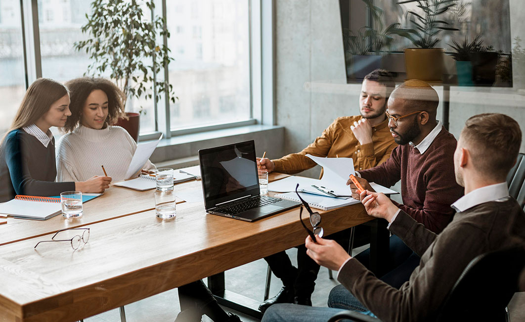 five people sitting at the table working
