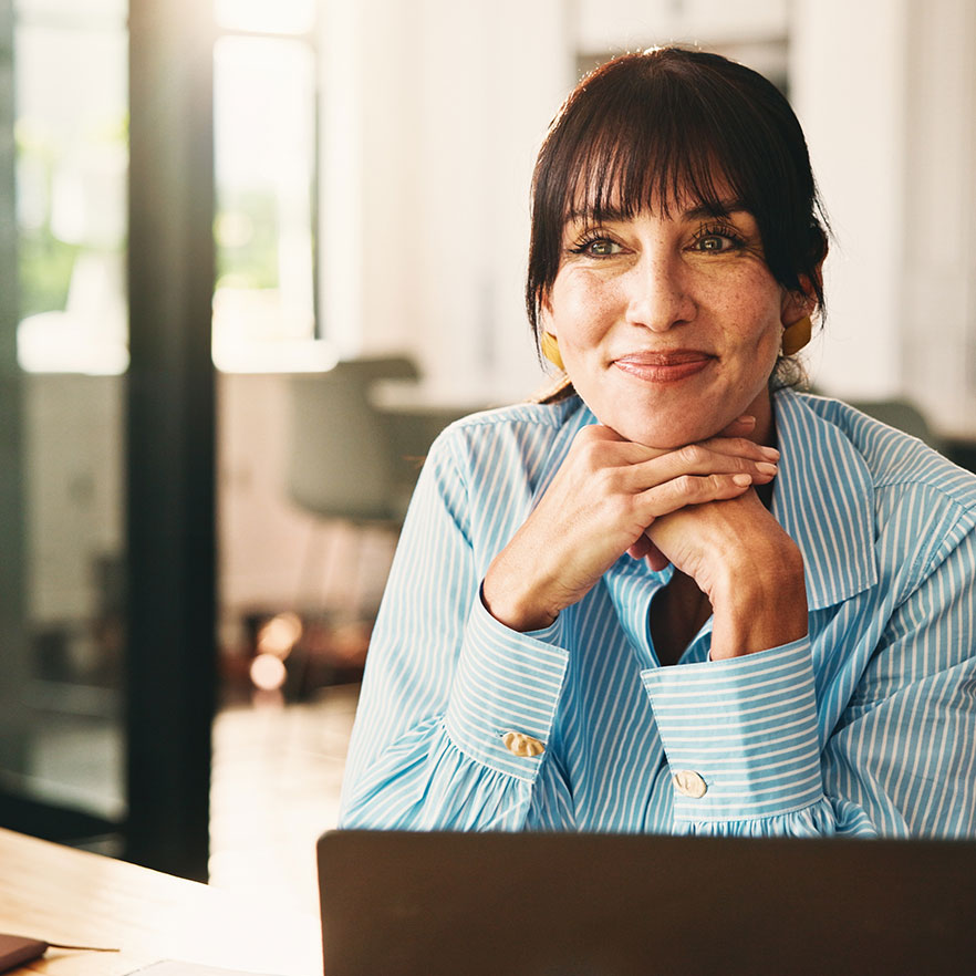 Business professional at a laptop in a bright modern office